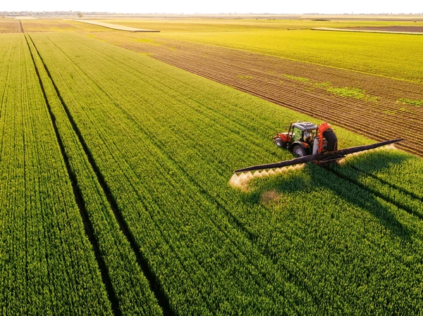 drone shot tractor spraying lush 600nw 2464594961